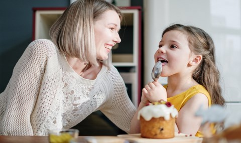 Woman in white jumper with little girl